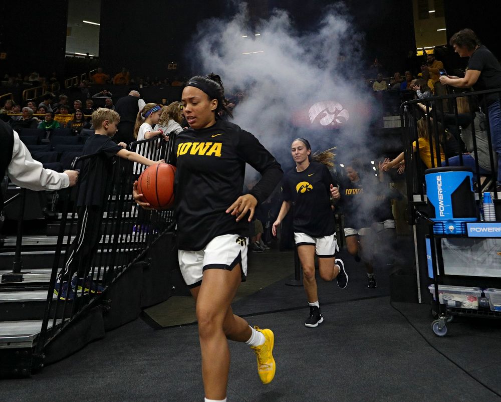 Iowa Hawkeyes guard Alexis Sevillian (5) leads her team onto the court before their game at Carver-Hawkeye Arena in Iowa City on Tuesday, December 31, 2019. (Stephen Mally/hawkeyesports.com)