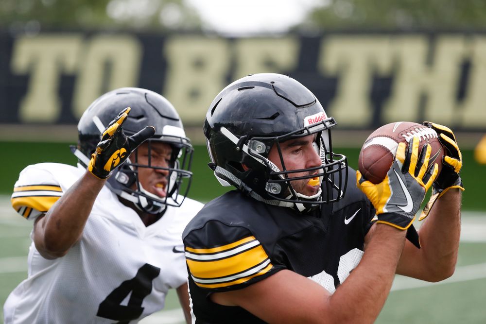 Iowa Hawkeyes wide receiver Nico Ragaini (89) and defensive back Josh Turner (4) during practice No. 4 of Fall Camp Monday, August 6, 2018 at the Hansen Football Performance Center. (Brian Ray/hawkeyesports.com)