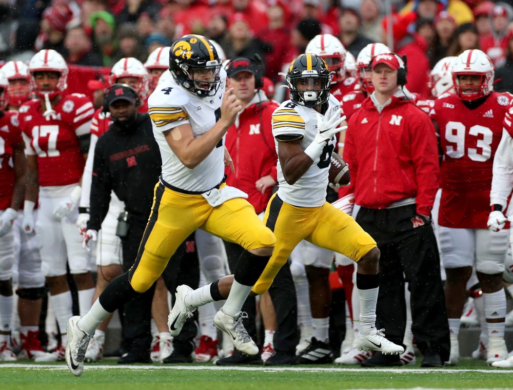 Iowa Hawkeyes quarterback Nate Stanley (4) blocks for wide receiver Ihmir Smith-Marsette (6) on his way to a touchdown against the Nebraska Cornhuskers Friday, November 29, 2019 at Memorial Stadium in Lincoln, Neb. (Brian Ray/hawkeyesports.com)