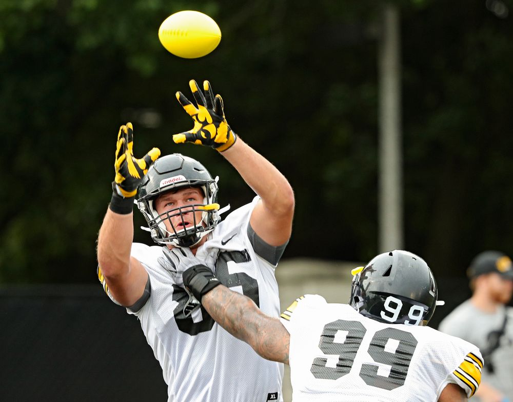 Iowa Hawkeyes defensive end Logan Lee (85) pulls in a ball as he runs a drill with defensive lineman Noah Shannon (99) durning Fall Camp Practice No. 17 at the Hansen Football Performance Center in Iowa City on Wednesday, Aug 21, 2019. (Stephen Mally/hawkeyesports.com)