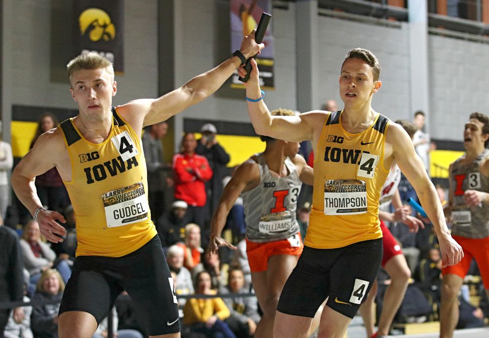 Iowa’s Spencer Gudgel (from left) takes the baton from Chris Thompson runs the men’s 1600 meter relay premier event during the Larry Wieczorek Invitational at the Recreation Building in Iowa City on Saturday, January 18, 2020. (Stephen Mally/hawkeyesports.com)