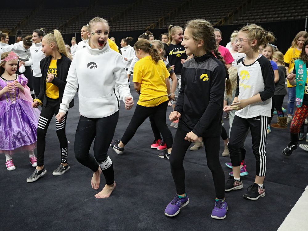 Iowa’s Lauren Guerin dances the Cha-Cha Slide with fans after their meet at Carver-Hawkeye Arena in Iowa City on Sunday, March 8, 2020. (Stephen Mally/hawkeyesports.com)