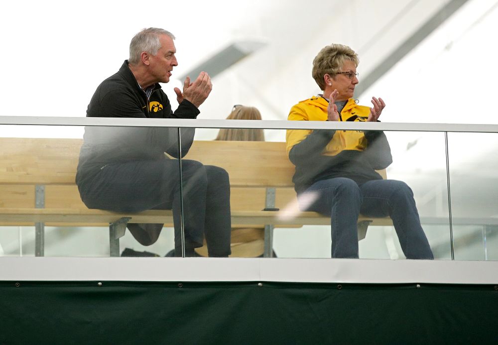Henry B. and Patricia B. Tippie Director of Athletics Chair Gary Barta (from left) and Deputy Director of Athletics/Senior Woman Administrator Barbara Burke clap during a match at the Hawkeye Tennis and Recreation Complex in Iowa City on Sunday, February 23, 2020. (Stephen Mally/hawkeyesports.com)