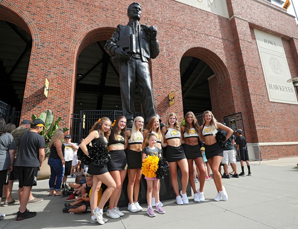 A fan takes a picture with Iowa Spirit Squad members during Kids Day at Kinnick Stadium in Iowa City on Saturday, Aug 10, 2019. (Stephen Mally/hawkeyesports.com)