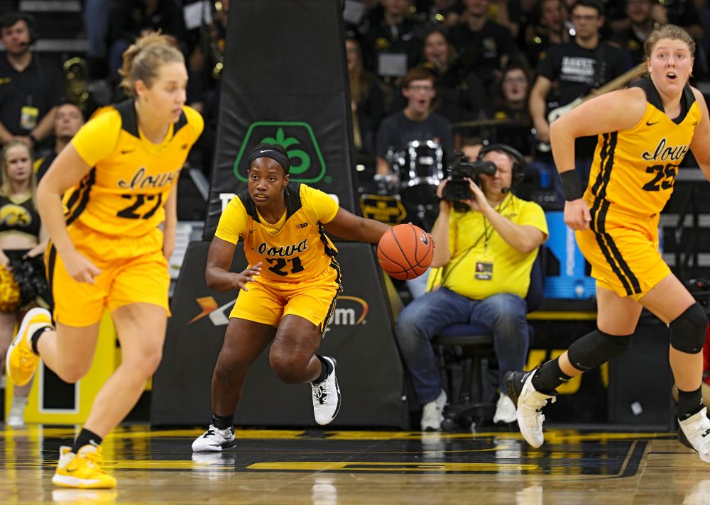 Iowa guard Zion Sanders (21) brings the ball down the court as guard Kathleen Doyle (22) and forward/center Monika Czinano (25) run during the third quarter of their game against Winona State at Carver-Hawkeye Arena in Iowa City on Sunday, Nov 3, 2019. (Stephen Mally/hawkeyesports.com)