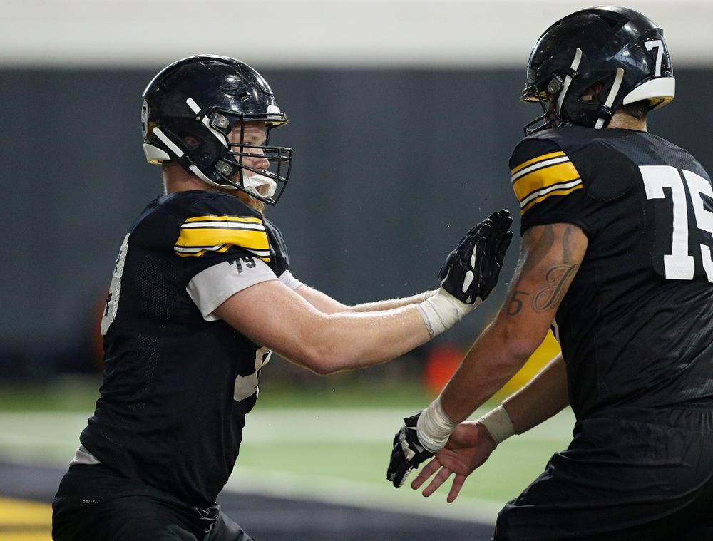 Iowa Hawkeyes offensive lineman Jack Plumb (79) works on a drill with offensive lineman Jeff Jenkins (75) during Fall Camp Practice No. 9 at the Hansen Football Performance Center in Iowa City on Monday, Aug 12, 2019. (Stephen Mally/hawkeyesports.com)