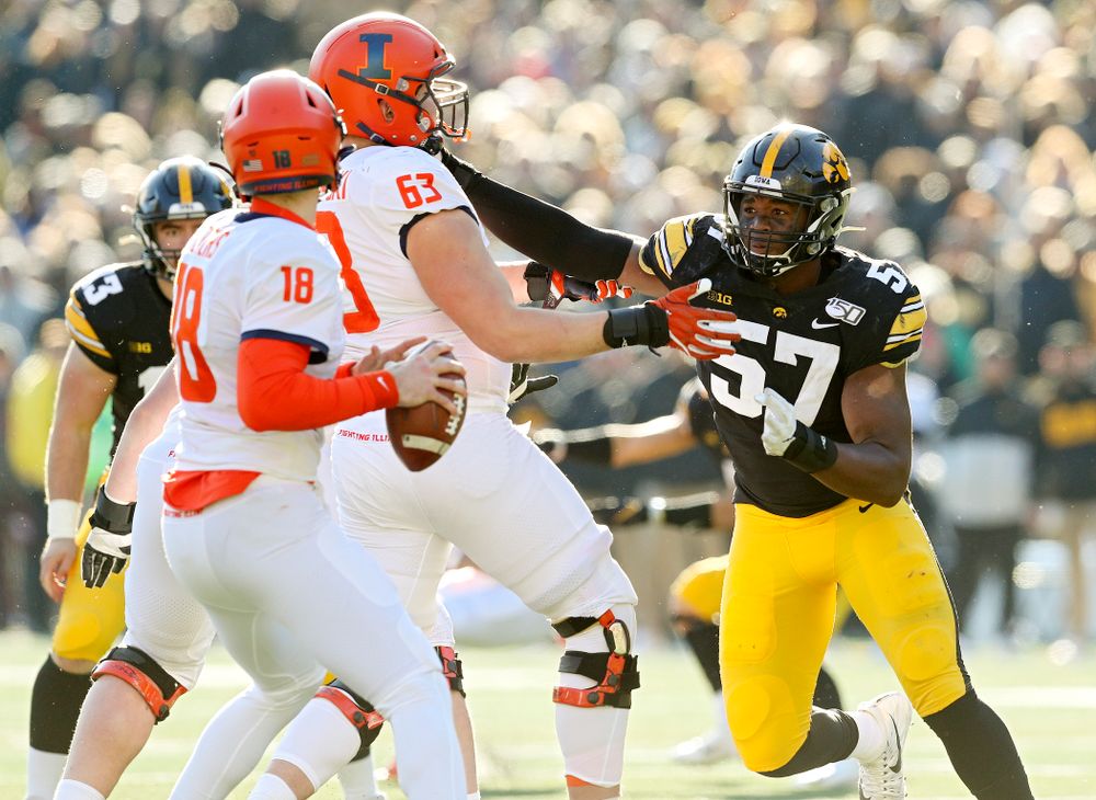 Iowa Hawkeyes defensive end Chauncey Golston (57) closes in on Illinois Fighting Illini quarterback Brandon Peters (18) during the fourth quarter of their game at Kinnick Stadium in Iowa City on Saturday, Nov 23, 2019. (Stephen Mally/hawkeyesports.com)