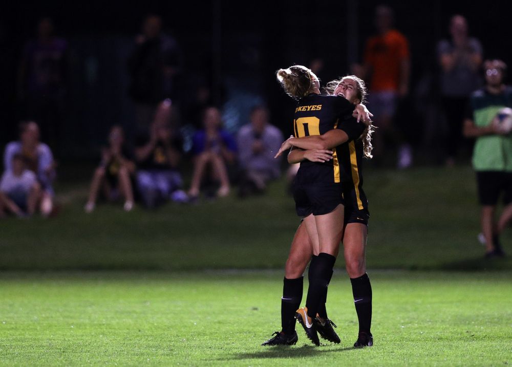 Iowa Hawkeyes midfielder/defender Natalie Winters (10) hugs forward Kaleigh Haus (4) after scoring during a 2-1 victory over the Iowa State Cyclones Thursday, August 29, 2019 in the Iowa Corn Cy-Hawk series at the Iowa Soccer Complex. (Brian Ray/hawkeyesports.com)