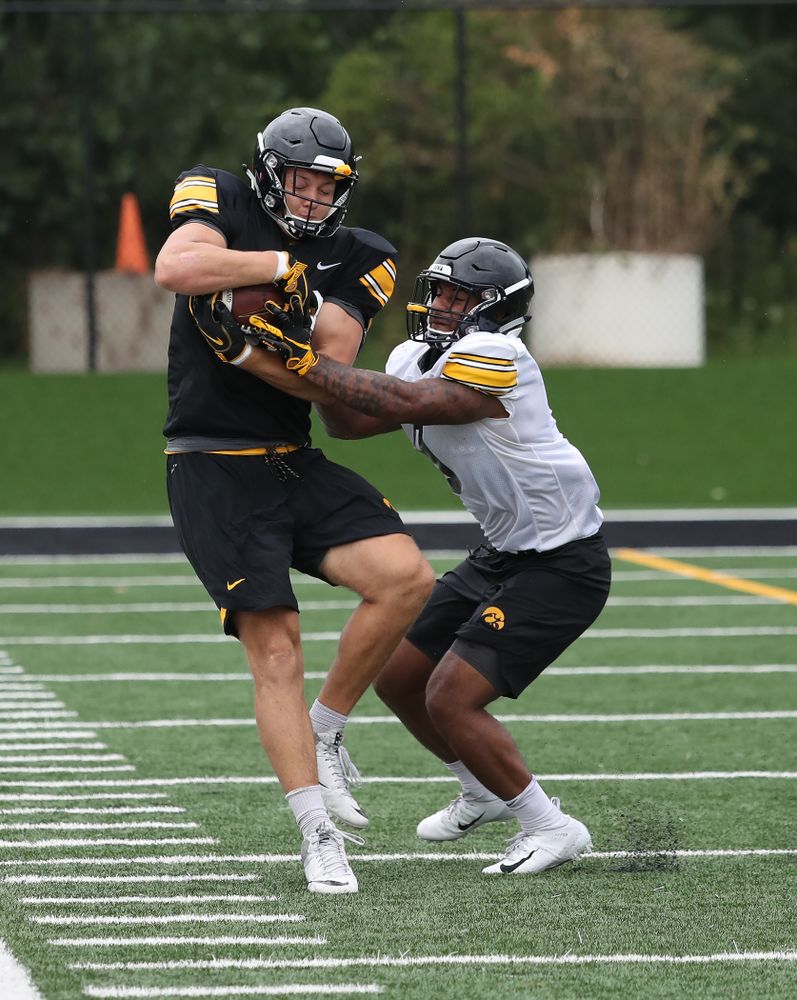 Iowa Hawkeyes tight end T.J. Hockenson (38) and defensive back Geno Stone (9) during practice No. 4 of Fall Camp Monday, August 6, 2018 at the Hansen Football Performance Center. (Brian Ray/hawkeyesports.com)