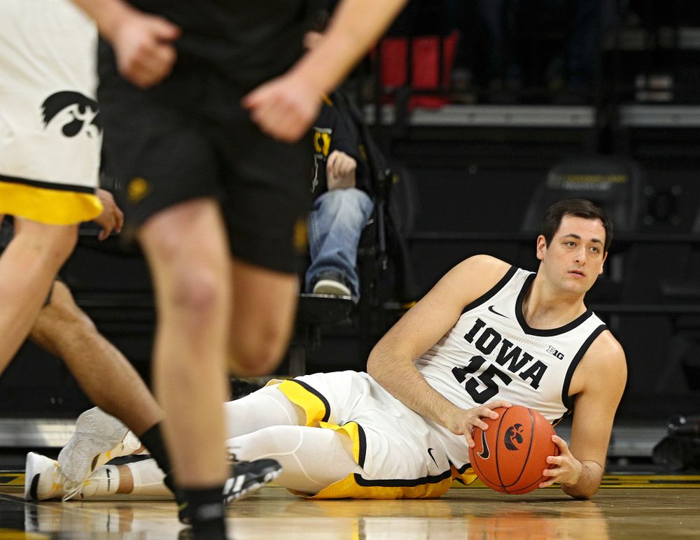 Iowa Hawkeyes forward Ryan Kriener (15) looks for someone to pass the ball to after diving for a loose ball on the court during the first half of their their game at Carver-Hawkeye Arena in Iowa City on Sunday, December 29, 2019. (Stephen Mally/hawkeyesports.com)