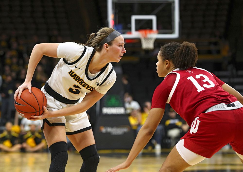 Iowa Hawkeyes guard Makenzie Meyer (3) keeps the ball away from Indiana Hoosiers guard Jaelynn Penn (13) during the fourth quarter of their game at Carver-Hawkeye Arena in Iowa City on Sunday, January 12, 2020. (Stephen Mally/hawkeyesports.com)