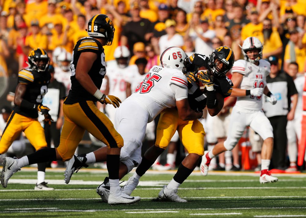 Iowa Hawkeyes defensive end Chauncey Golston (57) scoops up and returns a fumble against the Northern Illinois Huskies Saturday, September 1, 2018 at Kinnick Stadium. (Brian Ray/hawkeyesports.com)