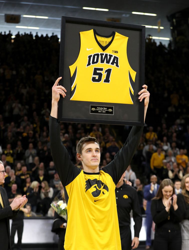 Iowa Hawkeyes forward Nicholas Baer (51) holds up his frames jersey during senior day activities before their game against the Rutgers Scarlet Knights  Saturday, March 2, 2019 at Carver-Hawkeye Arena. (Brian Ray/hawkeyesports.com)