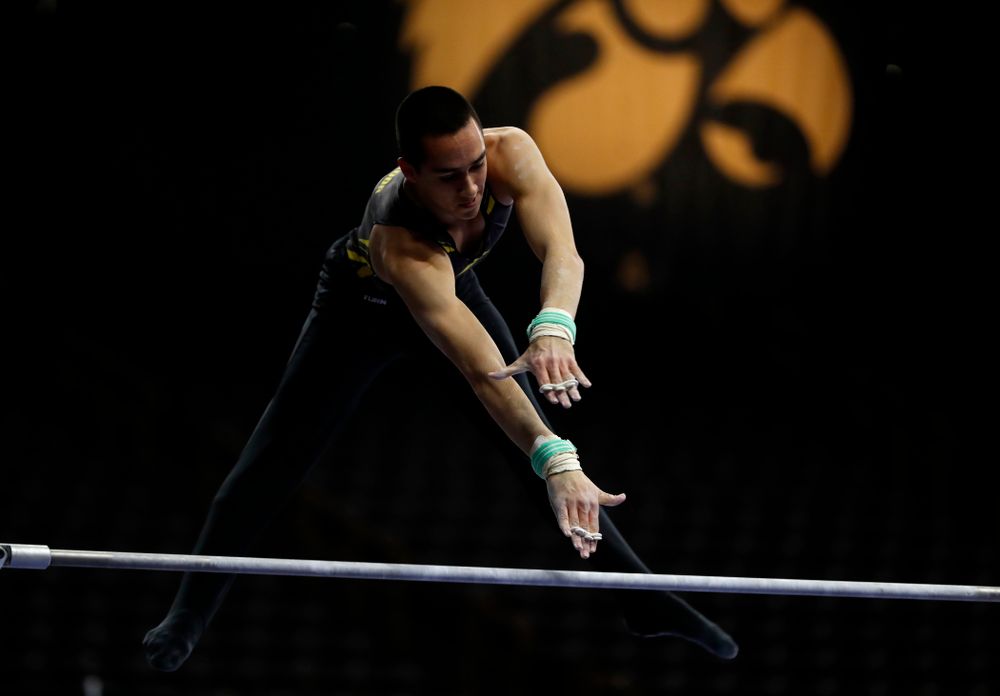 Andrew Herrador competes on the high bar against Minnesota and Air Force 