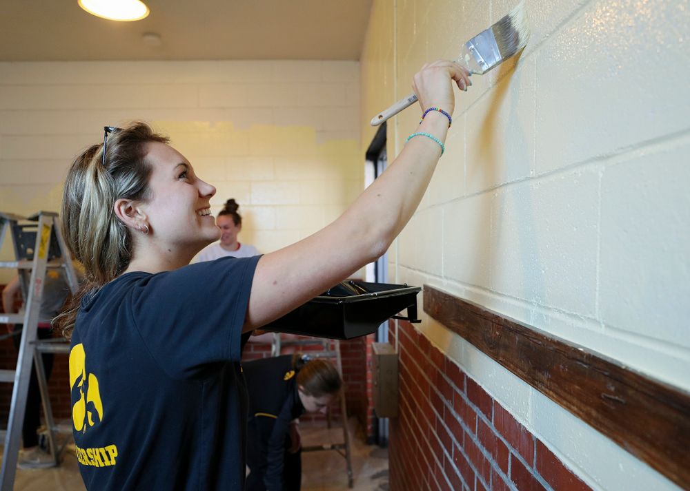Iowa women's swimming and diving teammates paint a room at the Coralville Community Food Pantry during the 21st annual ISAAC Hawkeye Day of Caring in Coralville on Sunday, Apr. 28, 2019. (Stephen Mally/hawkeyesports.com)