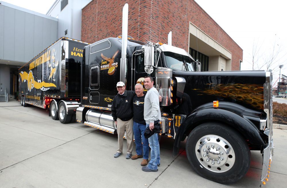 TanTara Transportation Corporation President Mike Riggan and operations manager Jeff Riggan stand with Iowa Football head equipment manager Greg Morris before departing for Tampa, Florida Friday, December 21, 2018 at the Hansen Football Performance Center. (Brian Ray/hawkeyesports.com)
