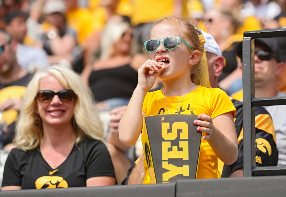 A young fan eats popcorn during the fourth quarter of their Big Ten Conference football game at Kinnick Stadium in Iowa City on Saturday, Sep 7, 2019. (Stephen Mally/hawkeyesports.com)