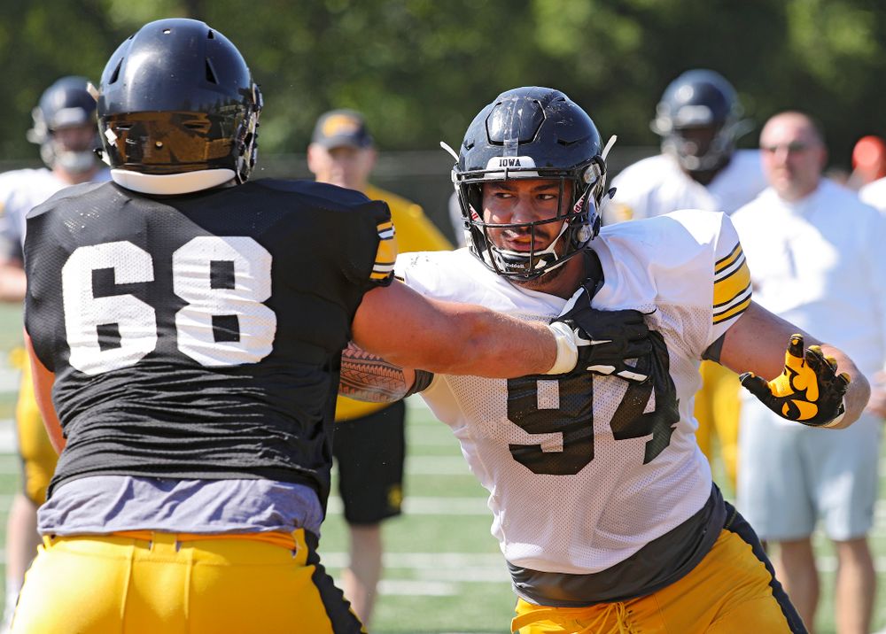 Iowa Hawkeyes offensive lineman Landan Paulsen (68) and defensive end A.J. Epenesa (94) run a drill during Fall Camp Practice #5 at the Hansen Football Performance Center in Iowa City on Tuesday, Aug 6, 2019. (Stephen Mally/hawkeyesports.com)