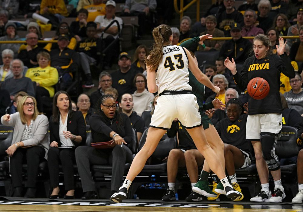 Iowa Hawkeyes forward Amanda Ollinger (43) pressures Michigan State Spartans guard Taryn McCutcheon (4) causing a turnover in front of the Iowa bench during the third quarter of their game at Carver-Hawkeye Arena in Iowa City on Sunday, January 26, 2020. (Stephen Mally/hawkeyesports.com)