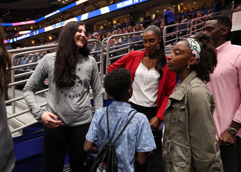 Iowa Hawkeyes forward Megan Gustafson (10) talks with Lisa Leslie and her family before being introduced during a timeout in the second half of the National Semi-Final between Baylor and Oregon Friday, April 5, 2019 at Amalie Arena in Tampa, FL. (Brian Ray/hawkeyesports.com)