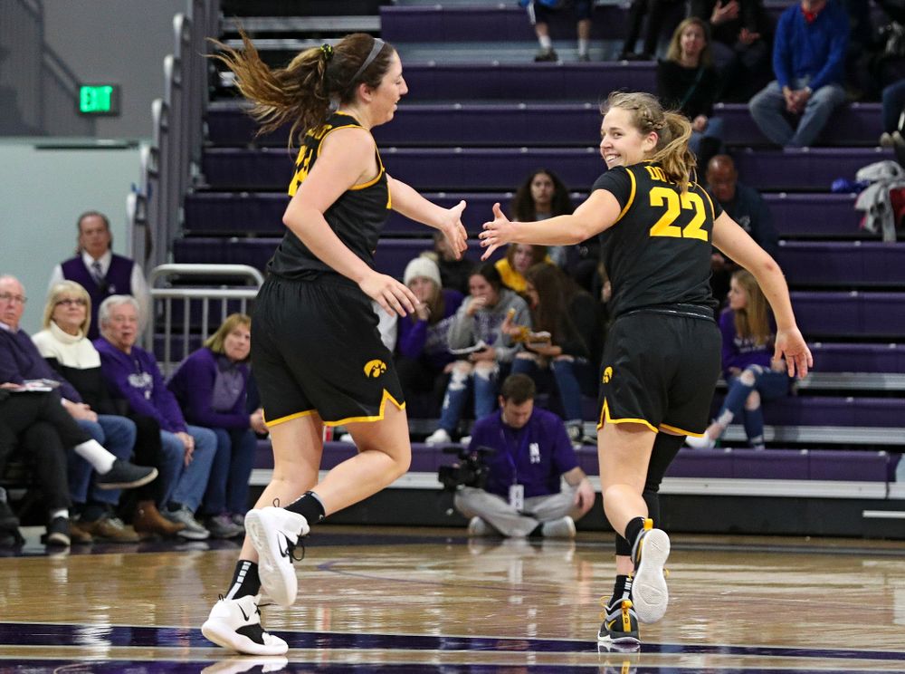 Iowa Hawkeyes guard Mckenna Warnock (14) gets a high-five from guard Kathleen Doyle (22) after Warnock made a 3-pointer during the third quarter of their game at Welsh-Ryan Arena in Evanston, Ill. on Sunday, January 5, 2020. (Stephen Mally/hawkeyesports.com)