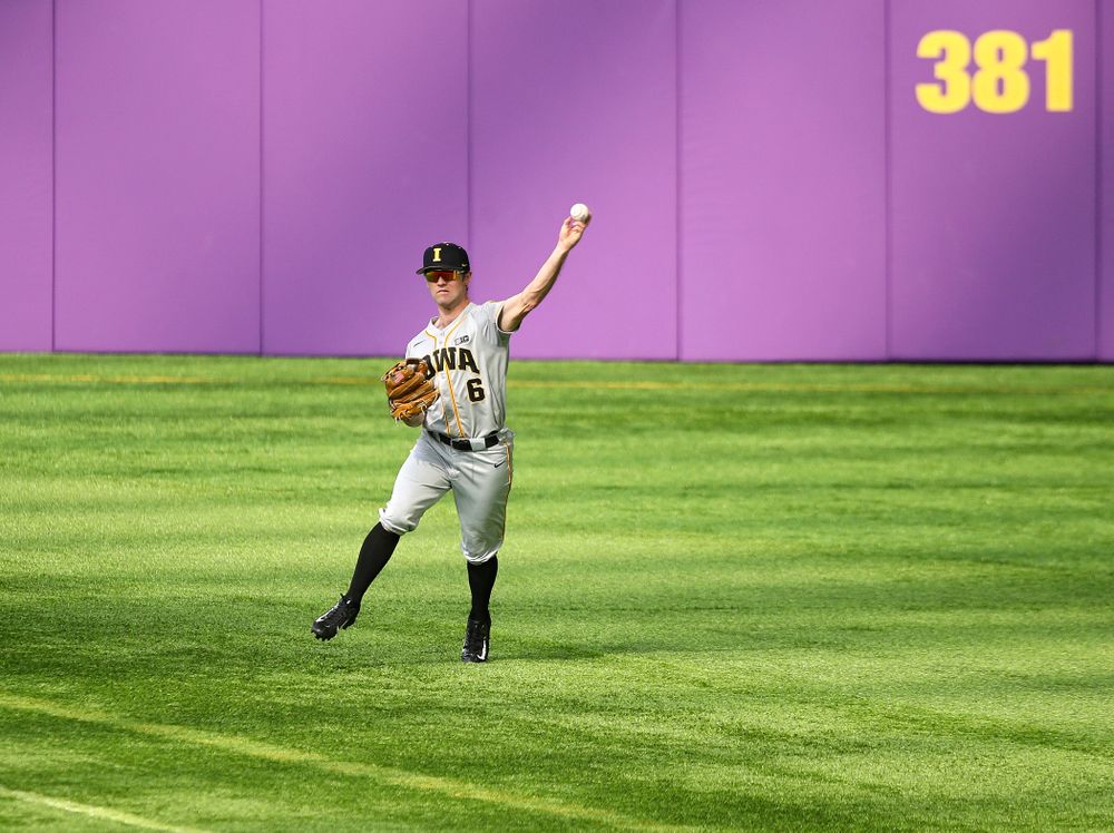 Iowa Hawkeyes outfielder Justin Jenkins (6) throws the ball back in to the infield after catching a fly ball for an out during the third inning of their CambriaCollegeClassic game at U.S. Bank Stadium in Minneapolis, Minn. on Friday, February 28, 2020. (Stephen Mally/hawkeyesports.com)