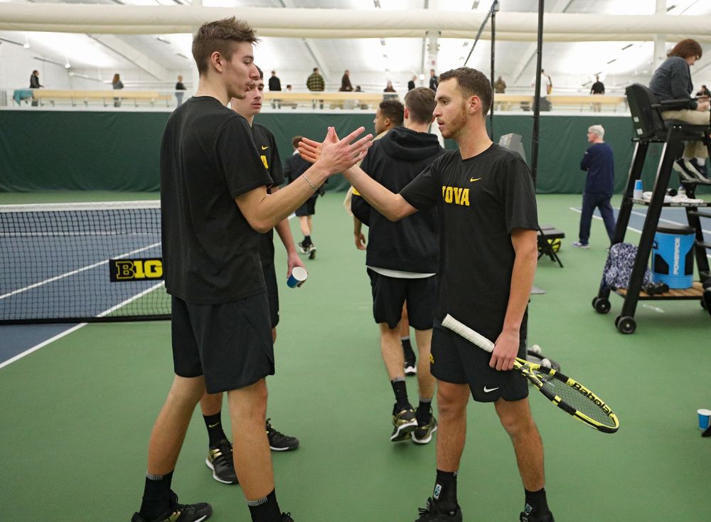 Iowa’s Nikita Snezhko (from left) celebrates with Kareem Allaf after Allaf won his match against Marquette at the Hawkeye Tennis and Recreation Complex in Iowa City on Saturday, January 25, 2020. (Stephen Mally/hawkeyesports.com)