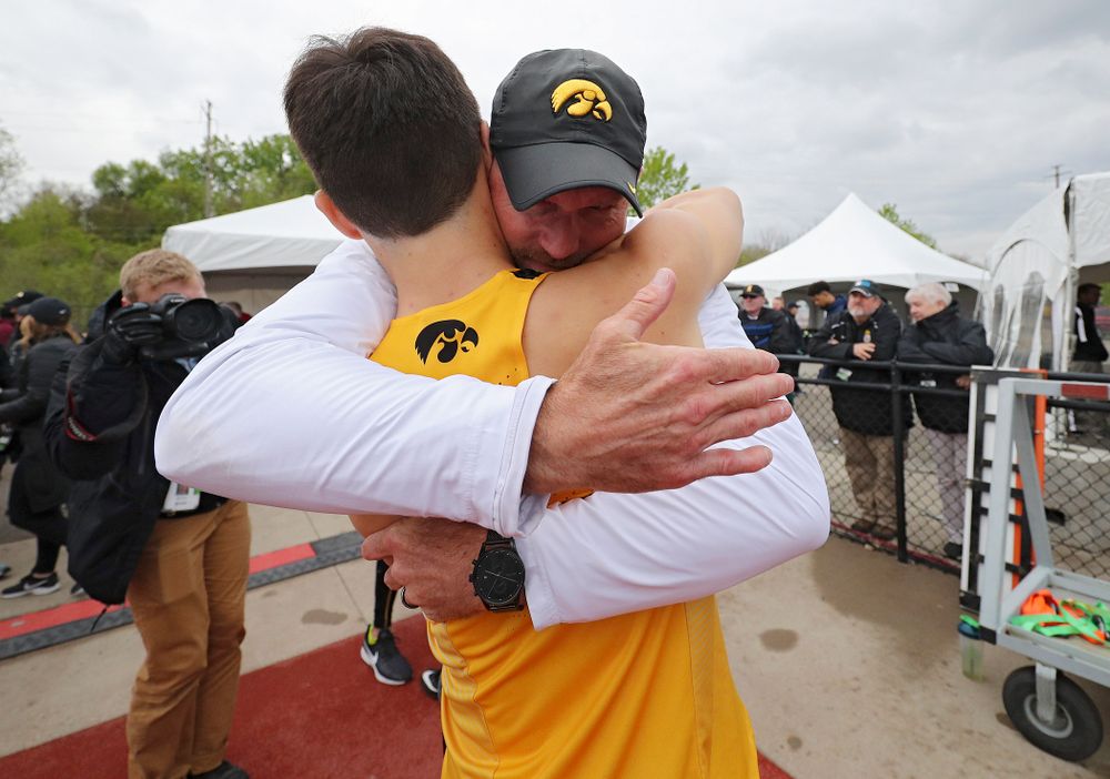 Iowa's Carter Lilly gets a hug from Director of Track and Field Joey Woody after they won the 1600 meter relay event on the third day of the Big Ten Outdoor Track and Field Championships at Francis X. Cretzmeyer Track in Iowa City on Sunday, May. 12, 2019. (Stephen Mally/hawkeyesports.com)