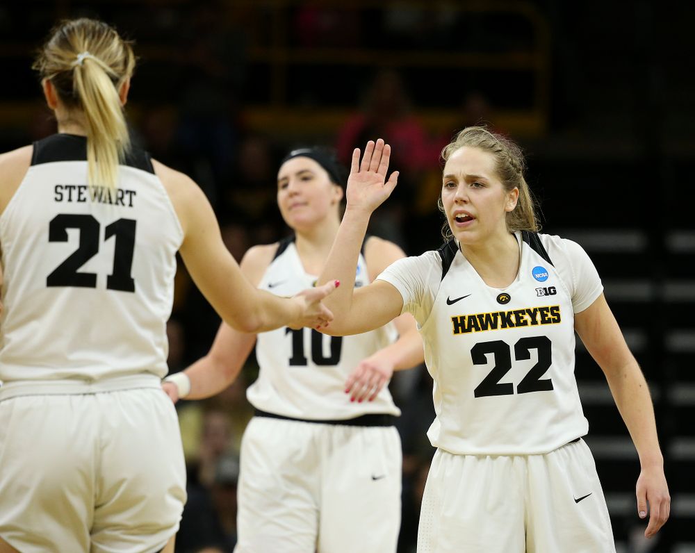 Iowa Hawkeyes guard Kathleen Doyle (22) greets forward Hannah Stewart (21) during the first round of the 2019 NCAA Women's Basketball Tournament at Carver Hawkeye Arena in Iowa City on Friday, Mar. 22, 2019. (Stephen Mally for hawkeyesports.com)