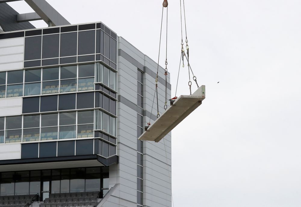 A section of precast concrete is lifted into place on the third deck of the north end zone Wednesday, June 6, 2018 at Kinnick Stadium. (Brian Ray/hawkeyesports.com)
