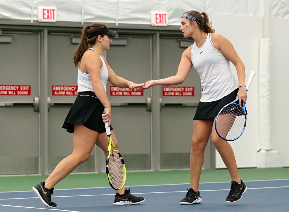 Iowa’s Danielle Bauers (from left) and Ashleigh Jacobs celebrate a point during their doubles match at the Hawkeye Tennis and Recreation Complex in Iowa City on Sunday, February 16, 2020. (Stephen Mally/hawkeyesports.com)