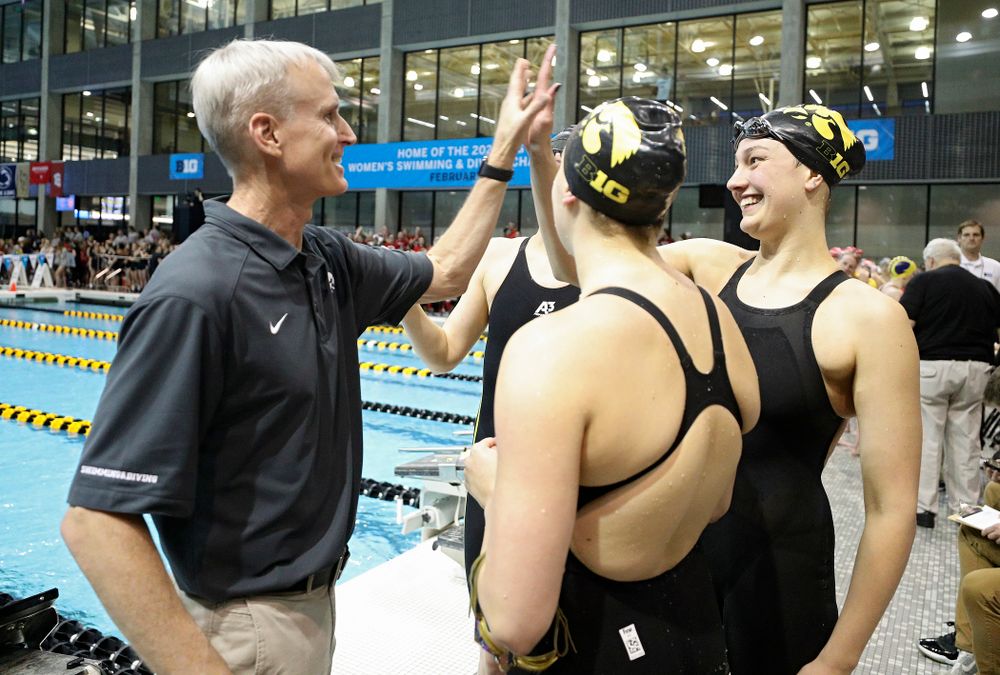 Iowa head coach Marc Long greets Hannah Burvill, Allyssa Fluit, and Emilia Sansome after they placed fourth in the 800 yard freestyle relay event during the 2020 Big Ten Women’s Swimming and Diving Championships at the Campus Recreation and Wellness Center in Iowa City on Wednesday, February 19, 2020. (Stephen Mally/hawkeyesports.com)