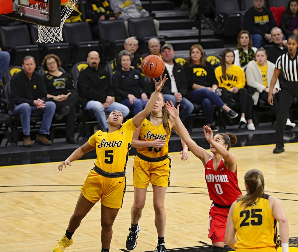 Iowa Hawkeyes guard Alexis Sevillian (5) pulls in a rebound as forward Amanda Ollinger (43) looks on during the first quarter of their game at Carver-Hawkeye Arena in Iowa City on Thursday, January 23, 2020. (Stephen Mally/hawkeyesports.com)