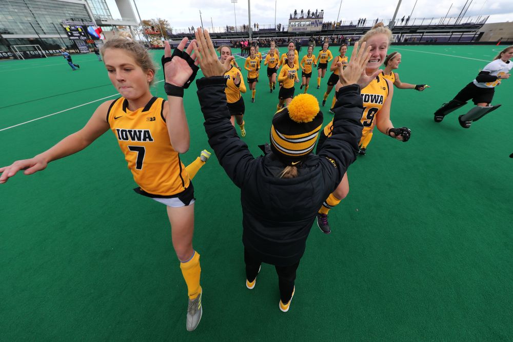 Iowa Hawkeyes Ellie Holley (7) and Ryley Miller (19) high five assistant coach Roz Ellis before their game against the Michigan Wolverines in the semi-finals of the Big Ten Tournament Friday, November 2, 2018 at Lakeside Field on the campus of Northwestern University in Evanston, Ill. (Brian Ray/hawkeyesports.com)