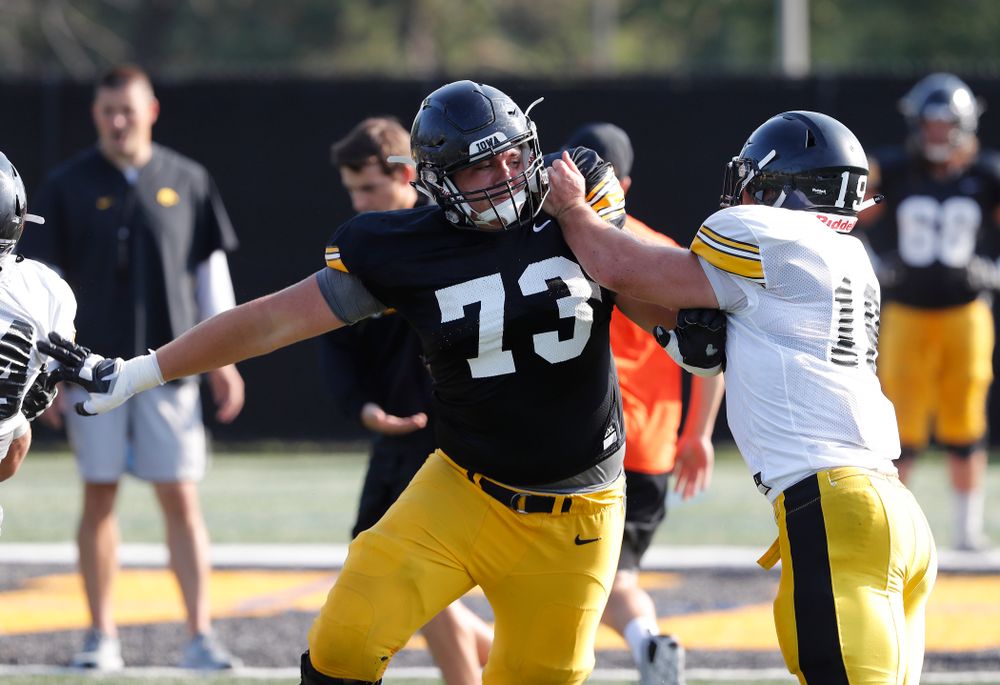 Iowa Hawkeyes offensive lineman Cody Ince (73) and linebacker Mike Timm (19) during camp practice No. 17 Wednesday, August 22, 2018 at the Kenyon Football Practice Facility. (Brian Ray/hawkeyesports.com)
