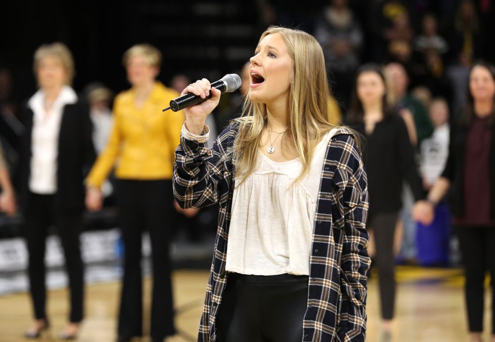 Iowa Hawkeyes head coach Lisa Bluder watches as her daughter Emma sings the National Anthem before the Iowa Hawkeyes game against the Northwestern Wildcats Sunday, March 3, 2019 at Carver-Hawkeye Arena. (Brian Ray/hawkeyesports.com)