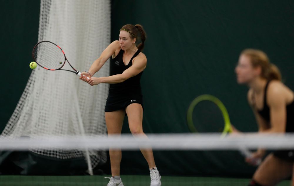 Iowa's Anastasia Reimchen and Montana Crawford play a doubles match against Marquette 