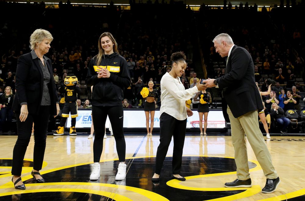 Former Hawkeye Tania Davis receives her Big Ten Tournament championship ring from  Henry B. and Patricia B. Tippie Director of Athletics Chair Gary Barta before the Iowa Hawkeyes game against Clemson Wednesday, December 4, 2019 at Carver-Hawkeye Arena. (Brian Ray/hawkeyesports.com)