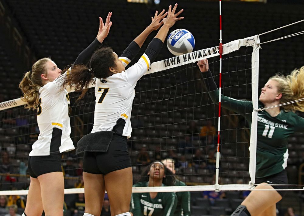 Iowa’s Brie Orr (7) blocks a shot as Hannah Clayton (18) looks on during the third set of their volleyball match at Carver-Hawkeye Arena in Iowa City on Sunday, Oct 13, 2019. (Stephen Mally/hawkeyesports.com)