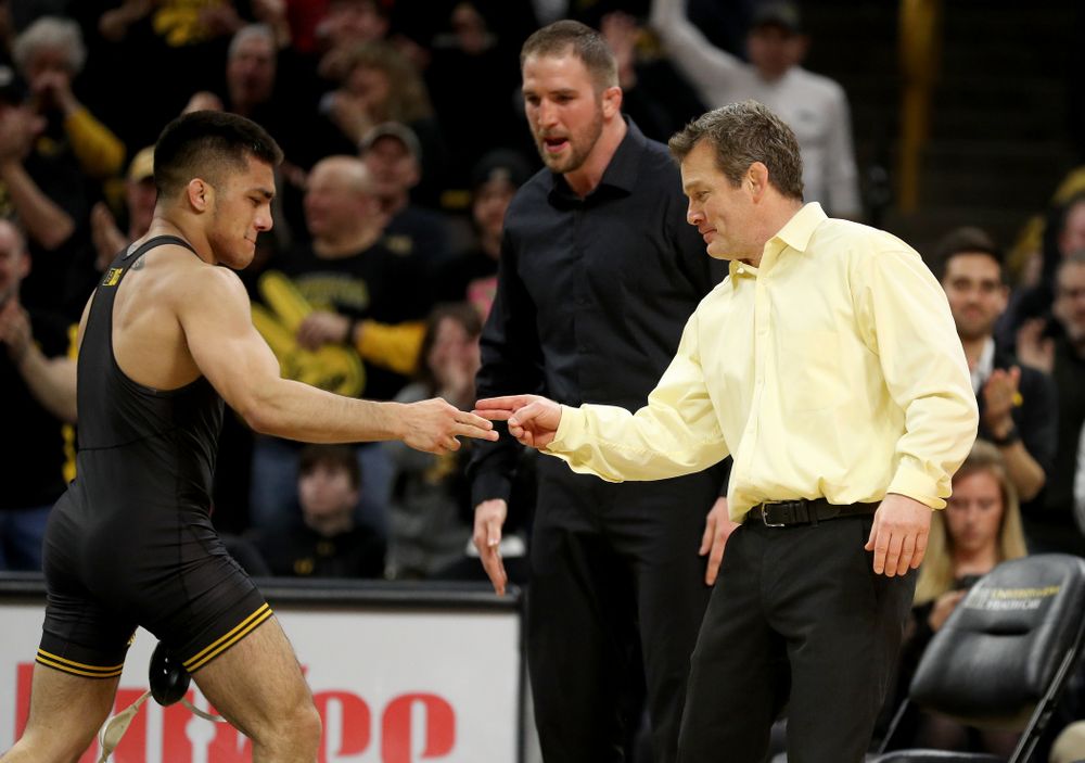 Iowa’s Pat Lugo and head coach Tom Brands after defeating Oklahoma State’s Boo Luwallen at 149 pounds Sunday, February 23, 2020 at Carver-Hawkeye Arena. Lugo won the match by fall. (Brian Ray/hawkeyesports.com)