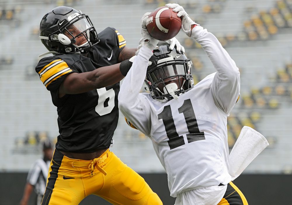Iowa Hawkeyes defensive back Michael Ojemudia (11) intercepts a pass intended for wide receiver Ihmir Smith-Marsette (6) during Fall Camp Practice No. 8 at Kids Day at Kinnick Stadium in Iowa City on Saturday, Aug 10, 2019. (Stephen Mally/hawkeyesports.com)