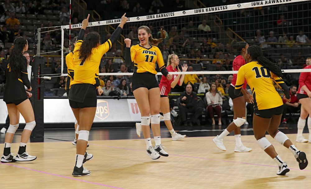 Iowa’s Halle Johnston (4), Courtney Buzzerio (2), Brie Orr (7), Blythe Rients (11), and Griere Hughes (10) celebrate after a score during their match at Carver-Hawkeye Arena in Iowa City on Sunday, Oct 20, 2019. (Stephen Mally/hawkeyesports.com)