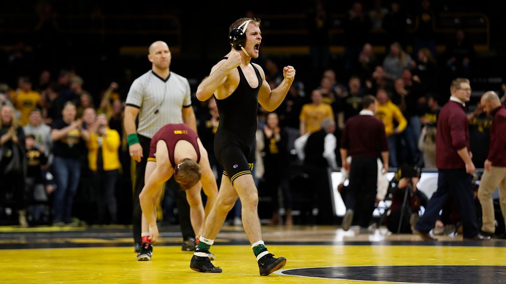 Iowa's Carter Happel celebrates after pinning  Minnesota's #10 Tommy Thorn at 141 pounds