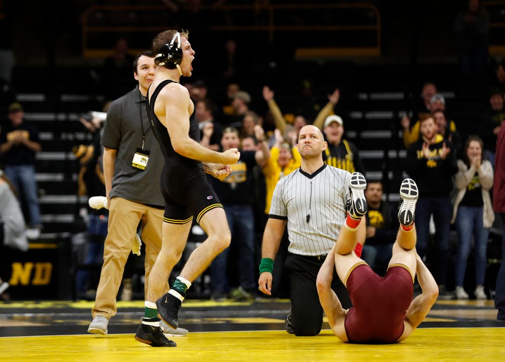 Iowa's Carter Happel celebrates after pinning  Minnesota's #10 Tommy Thorn at 141 pounds