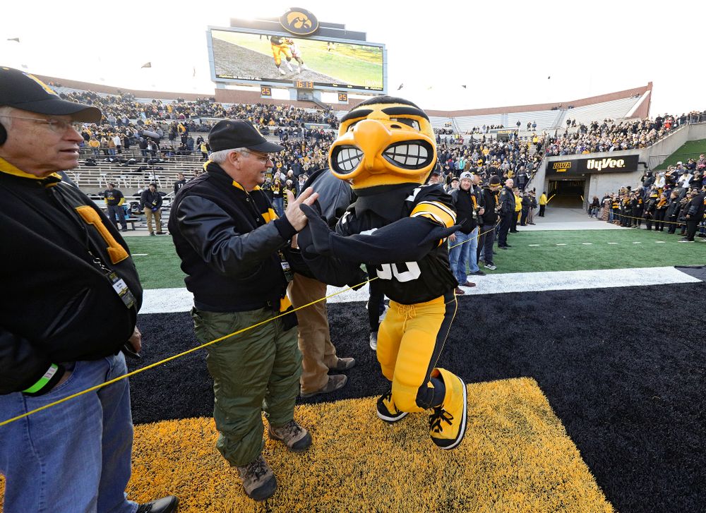 Herky gives high-fives to University of Iowa letterwinners before their game at Kinnick Stadium in Iowa City on Saturday, Nov 23, 2019. (Stephen Mally/hawkeyesports.com)
