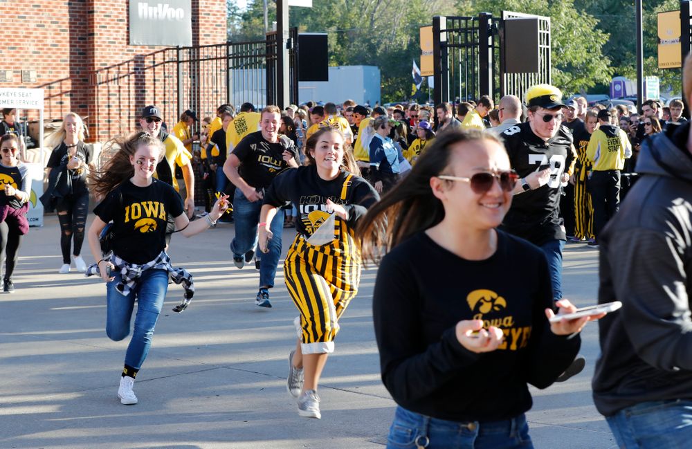 Students run to get seats before the Iowa Hawkeyes game against the Wisconsin Badgers Saturday, September 22, 2018 at Kinnick Stadium. (Brian Ray/hawkeyesports.com)