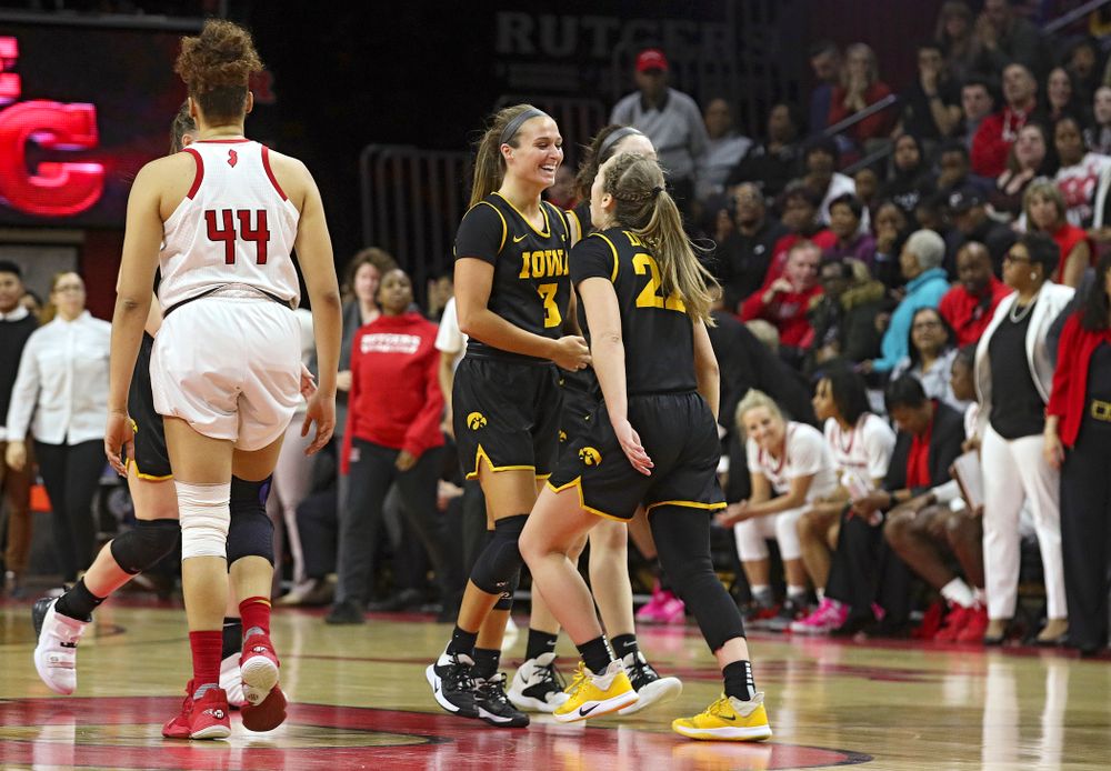 Iowa guard Makenzie Meyer (3) celebrates with guard Kathleen Doyle (22) after making a 3-pointer during the fourth quarter of their game at the Rutgers Athletic Center in Piscataway, N.J. on Sunday, March 1, 2020. (Stephen Mally/hawkeyesports.com)