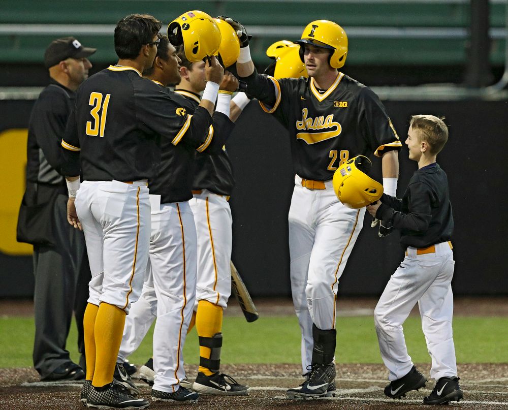 Iowa Hawkeyes left fielder Chris Whelan (28) is greeted at home after hitting a 3-run home run during the ninth inning of their game against Illinois State at Duane Banks Field in Iowa City on Wednesday, Apr. 3, 2019. (Stephen Mally/hawkeyesports.com)