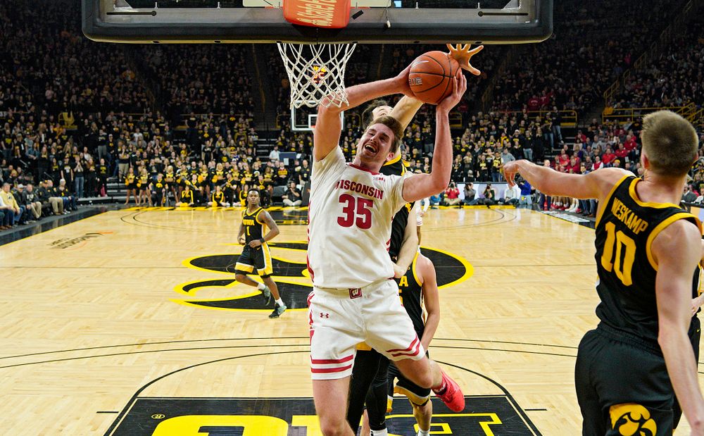 Iowa Hawkeyes forward Ryan Kriener (15) blocks a shot by Wisconsin Badgers forward Nate Reuvers (35) during the first half of their game at Carver-Hawkeye Arena in Iowa City on Monday, January 27, 2020. (Stephen Mally/hawkeyesports.com)