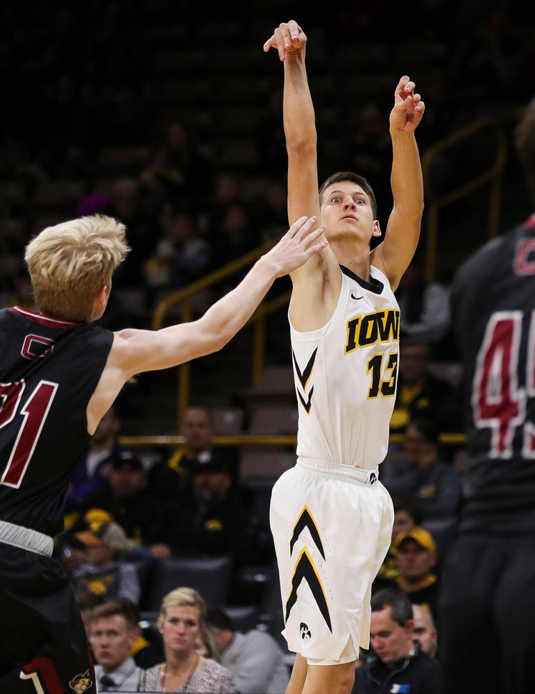 Iowa Hawkeyes guard Austin Ash (13) puts up a 3-pointer during a game against Guilford College at Carver-Hawkeye Arena on November 4, 2018. (Tork Mason/hawkeyesports.com)